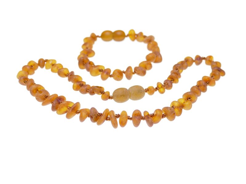 Oranžās krāsas dzintara krelles un aproce bērnam