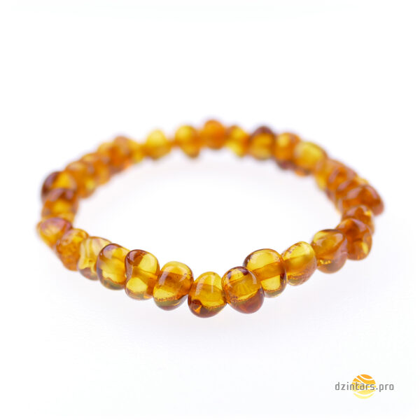 Baroka formas konjaka krāsas pulētā dzintara aproce bērniem 